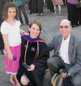 Reed at her law school graduation with her daughter and father.