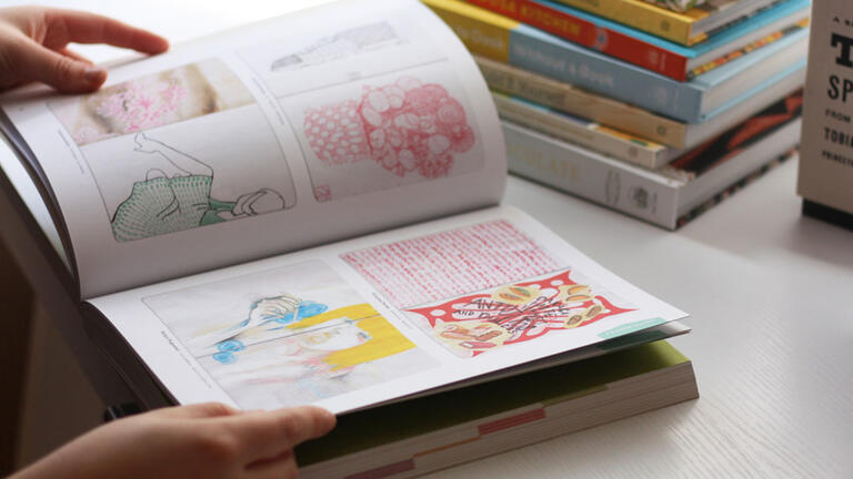 Artist sketch book with colorful drawings.