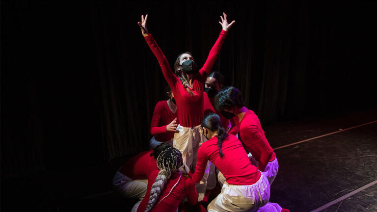 dancers in red and white perform in dance ensemble