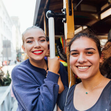Two students ride a cable car.