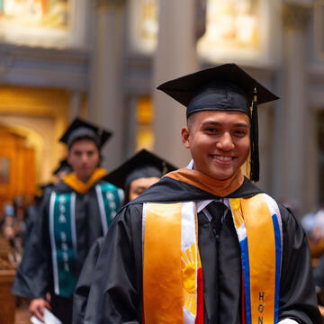 student in cap and gown during commencement ceremony