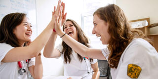Nursing students engage in a high five