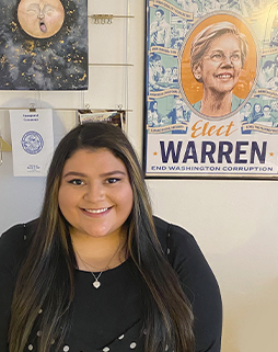Laura Flores with an Elizabeth Warren poster