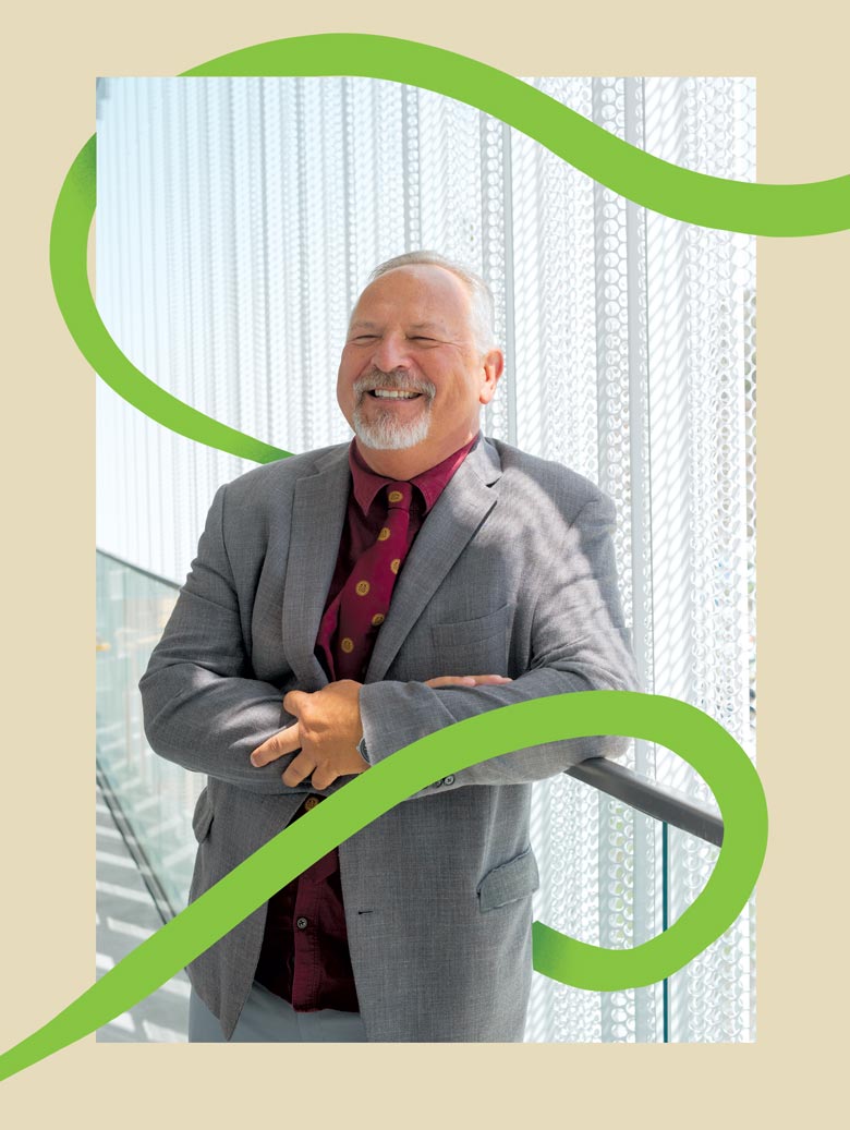 Matthew Motyka leaning against a wall with a green line encircling him