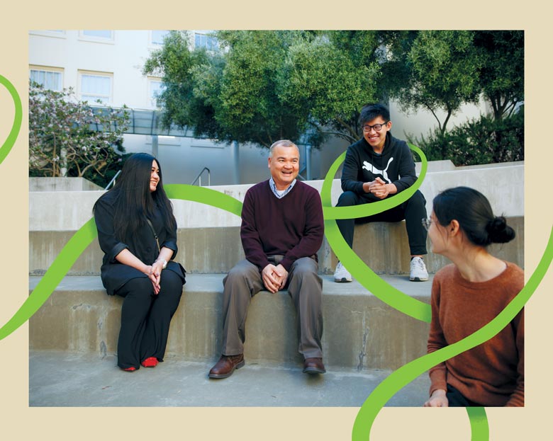 Joseph Nguyen seated in an amphitheater with students.