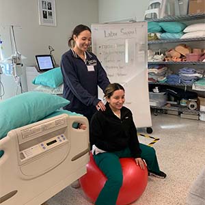 Ashley Cruz and a patient on a medicine ball
