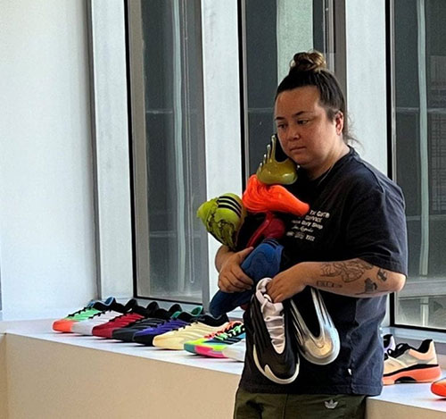 Rachel Cain Holding sport shoes