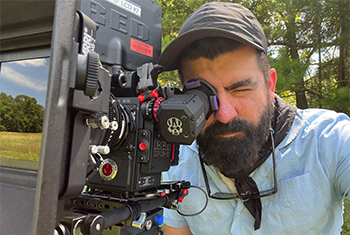 Jesse Feldberg ’06 looking the the view finders of a video camera on set of a TV show