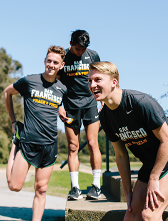 Women&#039;s cross country team members stretch