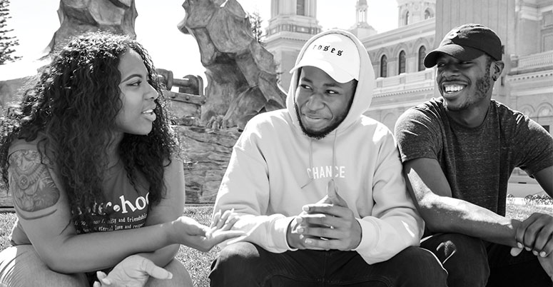 Students sitting outside on campus