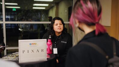 Diana Guardado talks with a student