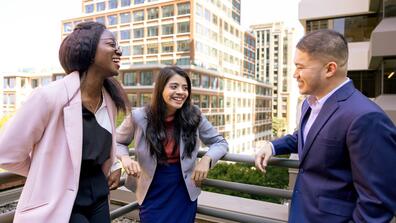 Three School of Management students chatting in professional-wear