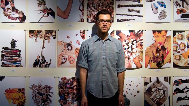 James Barela in front of a wall of art