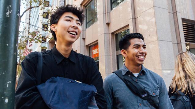 Students walk on a downtown street.