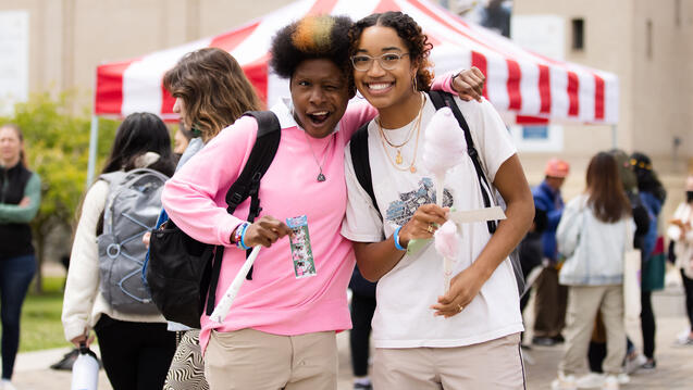 Two students pose and hug at the CAB carnival.