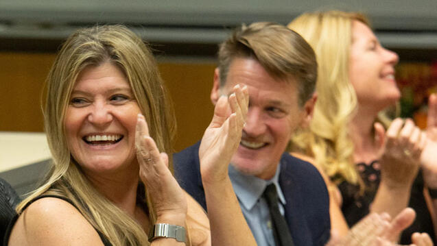 Alumni clapping for the speaker at an event