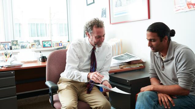 Faculty and student talking