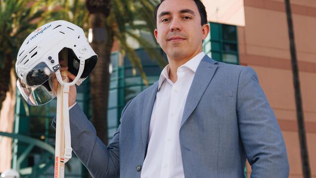 USF Sport Management Master&#039;s Program - Student holding a hockey helmet 