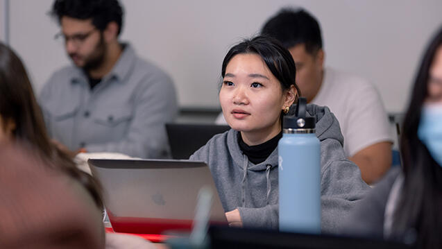 student listening to lecture in classroom