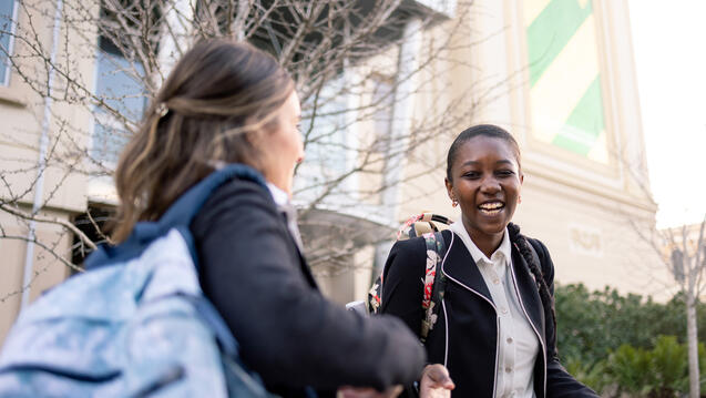 students walking together outside on campus