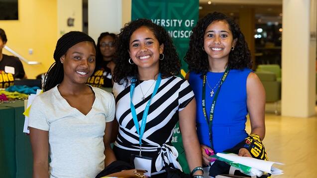 students smiling together at an event