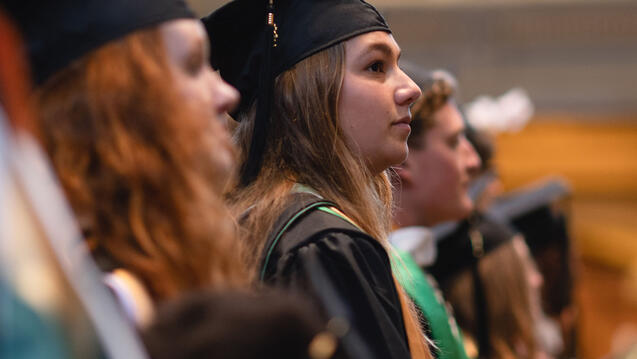 Graduates sitting in a row in the church.