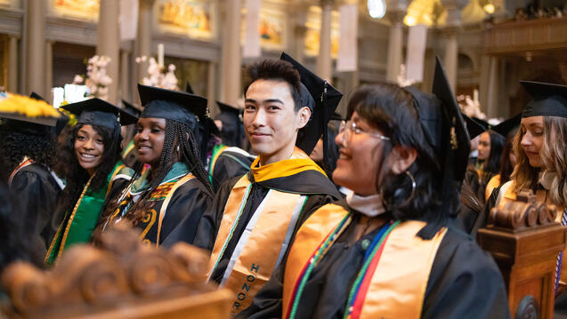 students sitting at saint ignatius church during commencement