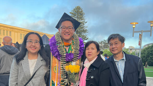 norman feng standing with his family during graduation