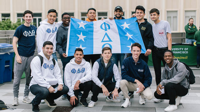 Phi Delta Theta members smile together on usf campus