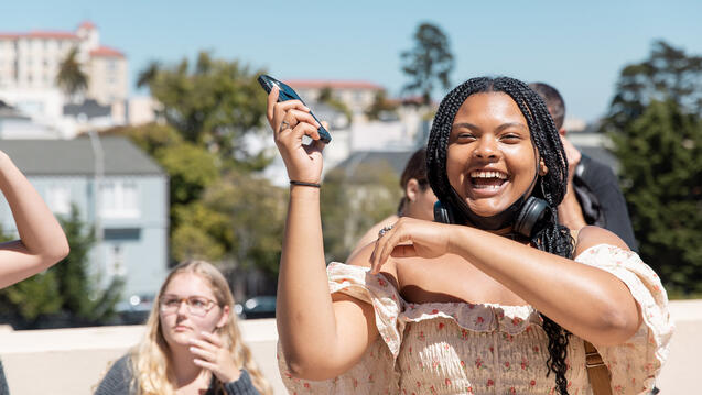 student laughing and dancing outside