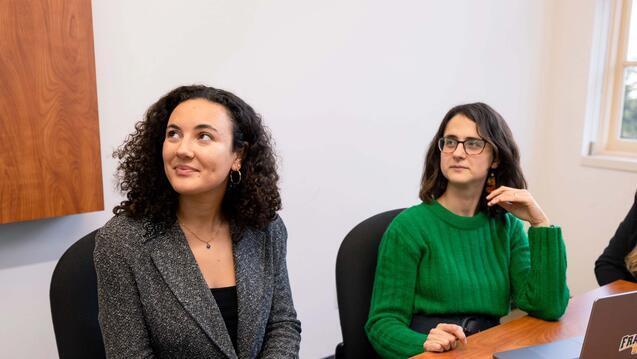 Two USF students actively listening in class