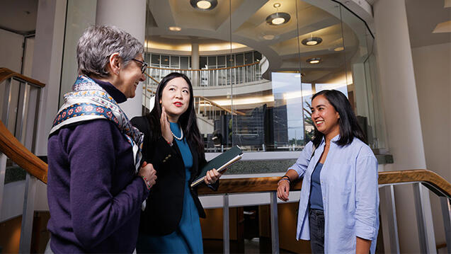 USF student chatting with law professors in USF Law Building