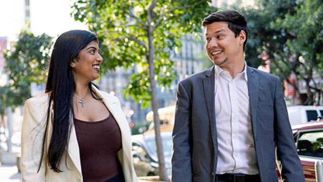Two USF graduate students walking outside downtown campus