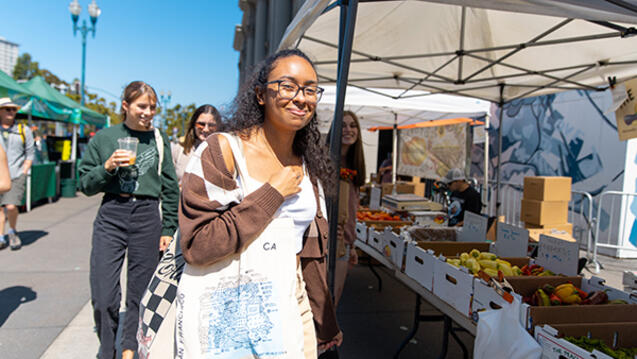 students walk around farmer's market