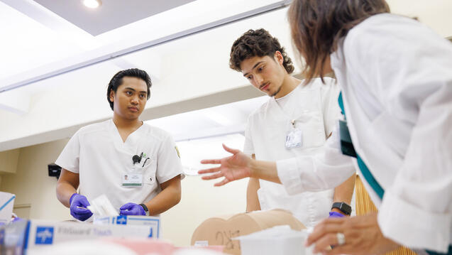 students in scrubs practice nursing skills