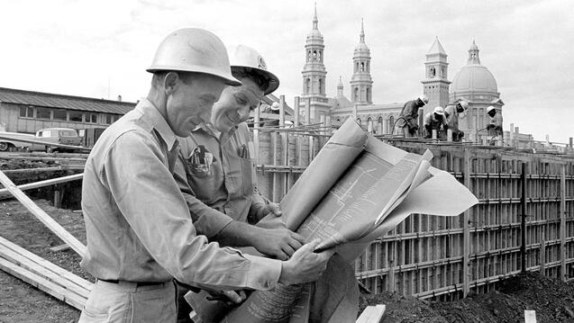 construction crew reviewing blueprints for The Harney Science Center in 1965