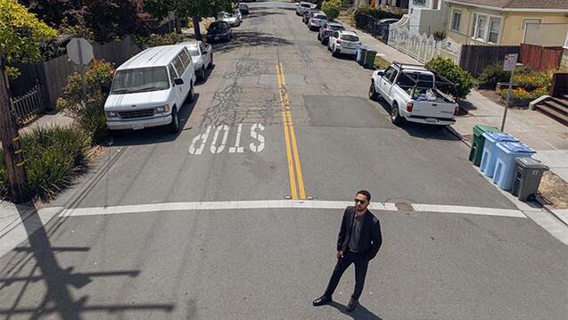 Person standing in a crosswalk on the street