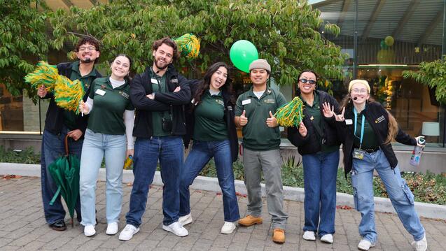 Seven USF students posing on campus together