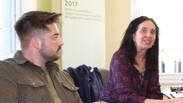 student and faculty sit together
