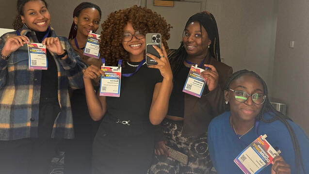 Beatrice Johnson-Drysdale taking a mirror selfie with people in the middle at the NSBE conference