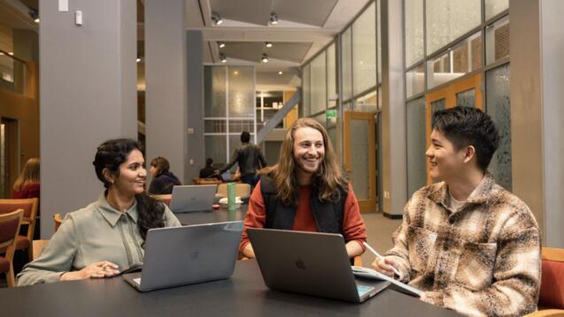 3 students chatting and smiling