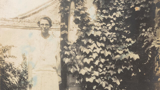 woman stands in front of building