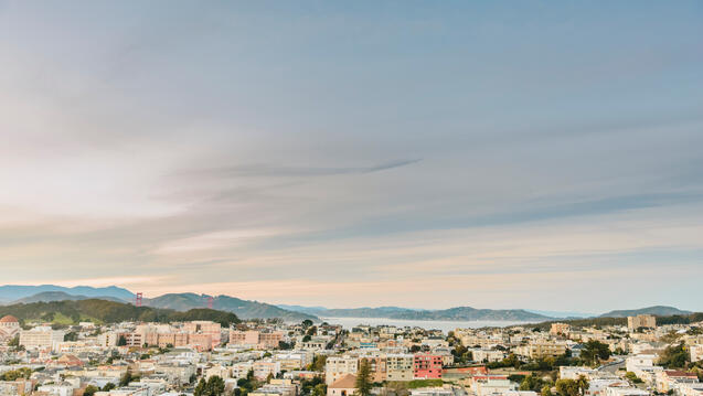 Golden Gate Bridge, houses, and San Francisco Bay. 
