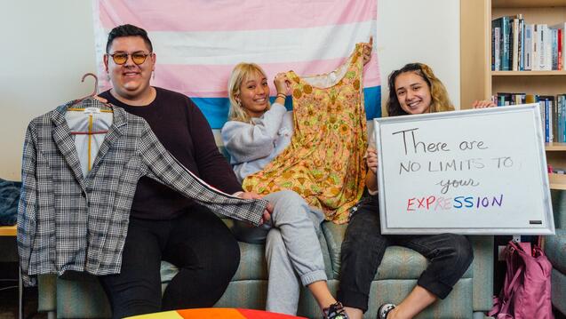 Students at the gender affirming clothing closet, sign says there are no limits to your expression