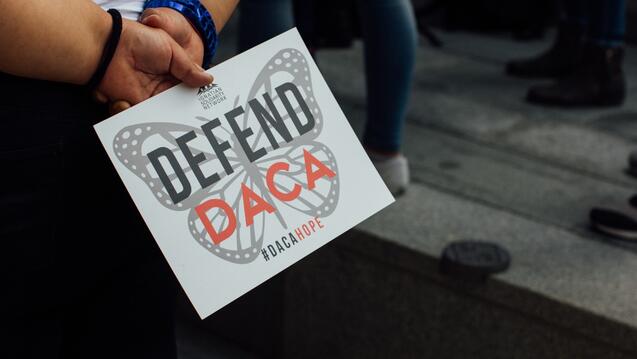 Defend DACA sign in student's hands
