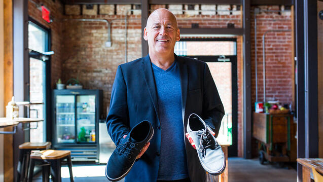 David Batstone holds a pair of shoes