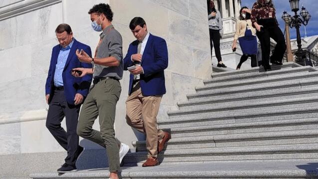 Julian Soraporu interviews people on the Capitol steps