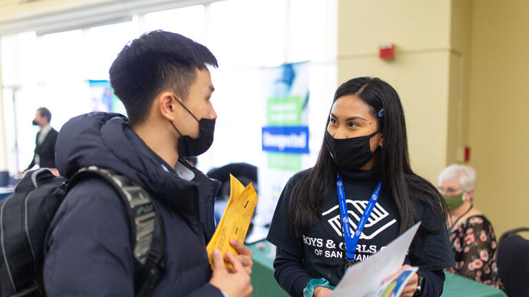 A Boys and Girls Club of San Francisco recruiter talking with a student at Job Fest