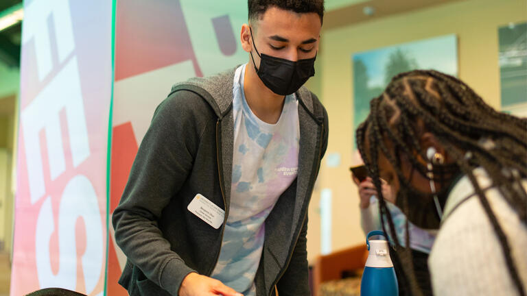 A Career Services worker helping a student at Job Fest