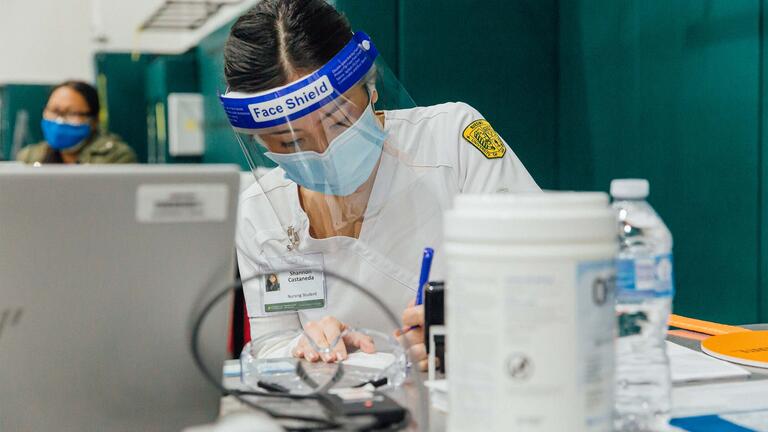 Nursing student works with vaccine supplies